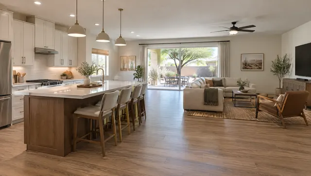 Mesa ranch home after a wall between a closed kitchen and the living room was removed: one open room with a new island facing the family room, continuous wood-look floor, sliding door to a patio with a mesquite tree
